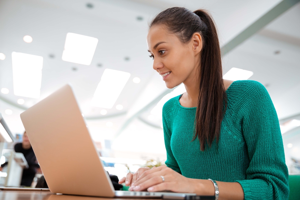 Adult learner working on a laptop.