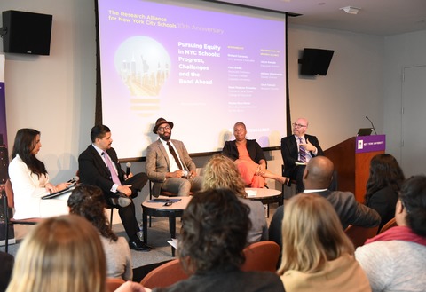 Panelists speaking at the event