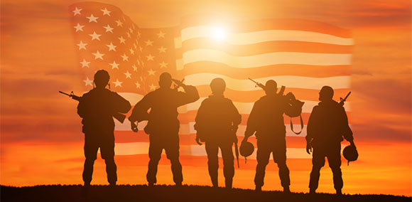Veterans overlooking a sunset