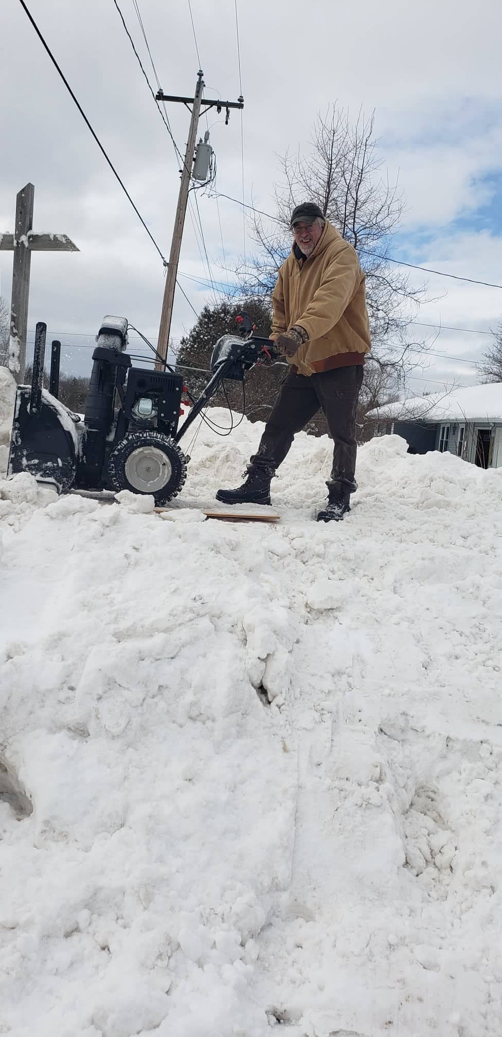 Photo of Bug Shed owner Rich Beasley with a snowblower