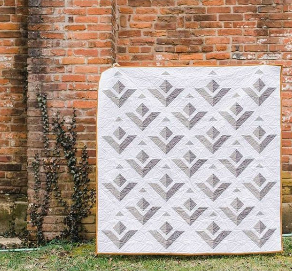 Kiley Ferons  How “fly“ is Kiley's Paper Planes quilt?! She desinged it in EQ and says the pattern is perfect for confident beginners! See more of her quilts on Instagram, @kileysquiltroom. 