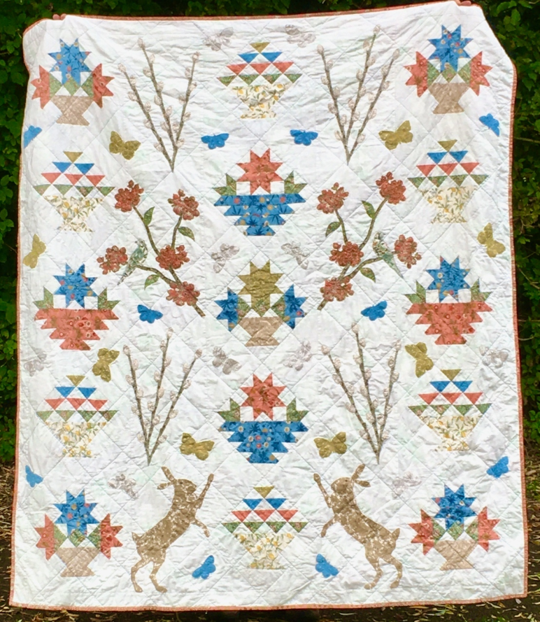 Fi Bowman  Which quilt blocks make you think of spring? Fi used pieced blocks from BlockBase for this quilt and drew the applique shapes in EQ8! See more photos of the “Signs of Spring“ quilt on her Instagram, @hobgoblin.cottage!