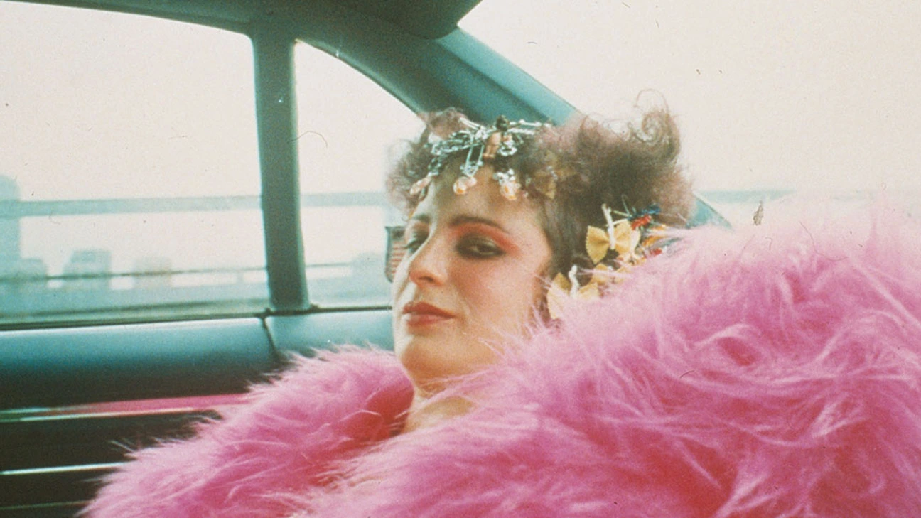 woman in a car with a huge pink fur coat