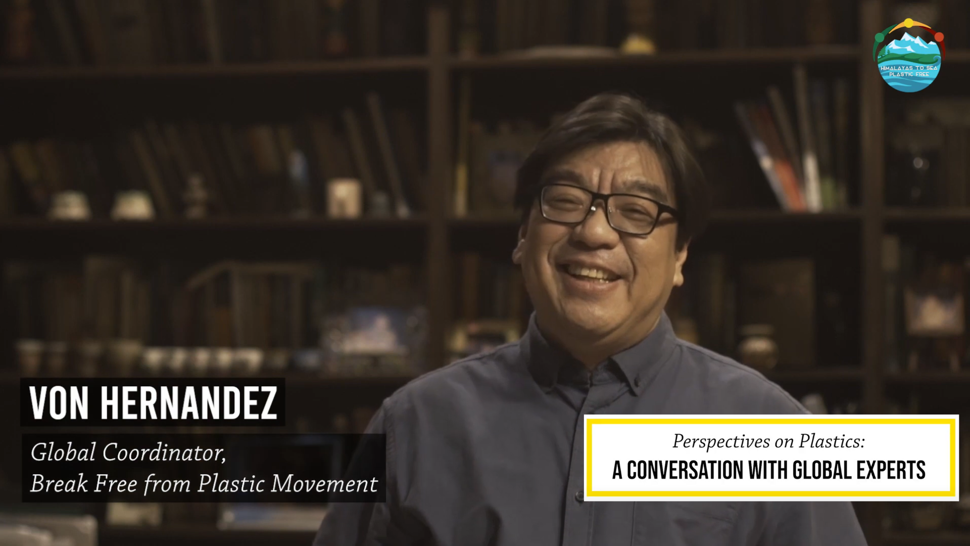 Image of the BFFP Global Coordinator, Von Hernandez, during his interview with Himalayas to Sea, Plastic Free. Von is sitting in a library, smiling at the camera.