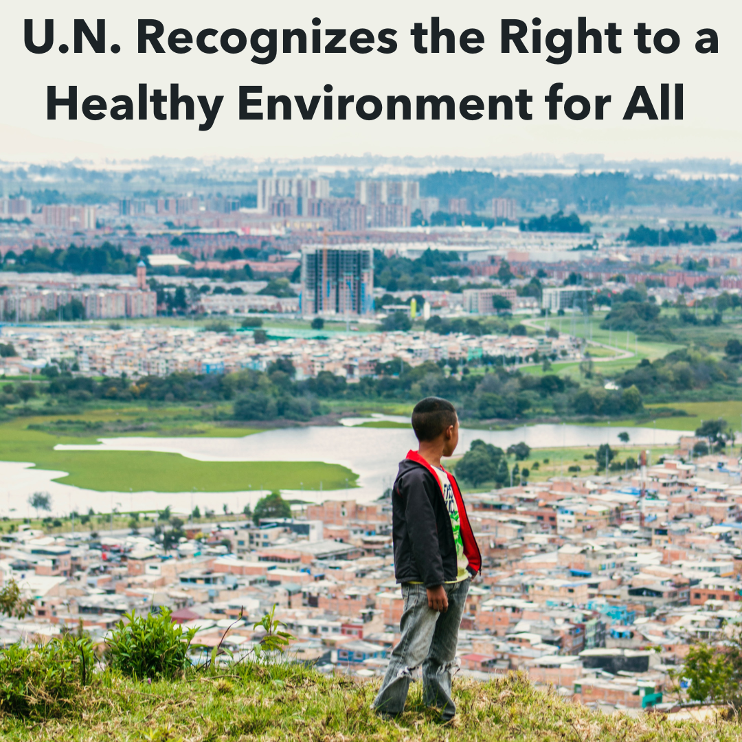 An image of a young child looking over the city of Bogotá, Colombia, with text above that reads, “U.N. Recognizes the Right to a Healthy Environment for All“