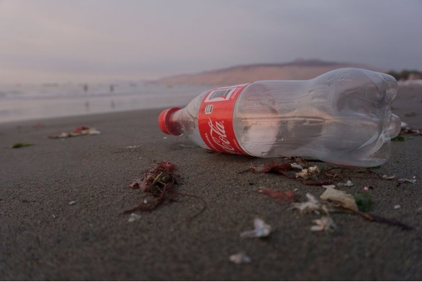 Picture of a Coca-Cola plastic bottle on a beach