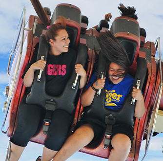 Visitors on a thrilling amusement park ride.