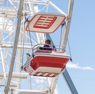 A child riding in a ferris wheel.
